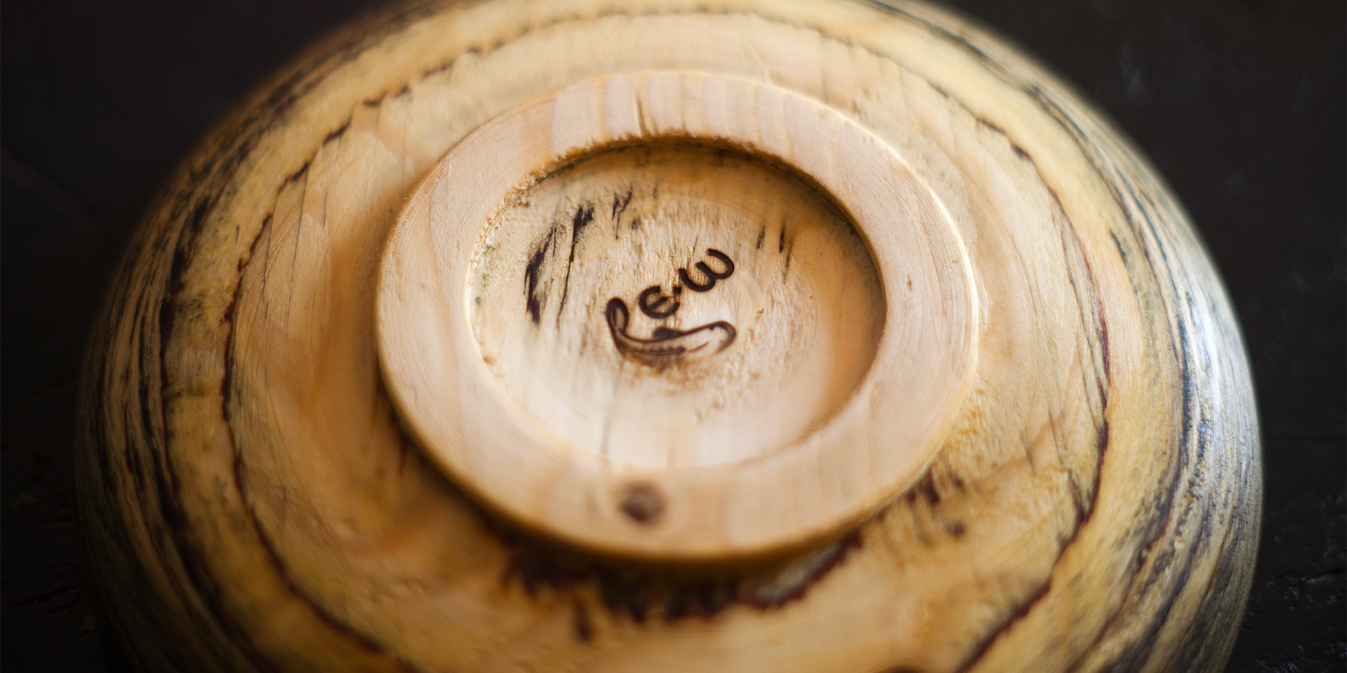 The logo burned into the base of a plate.